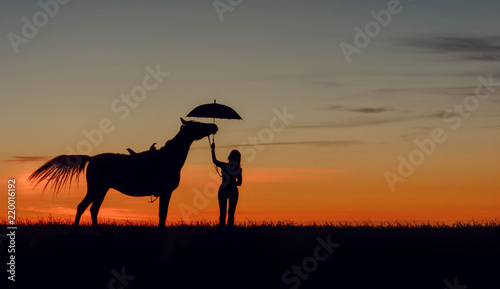 Curious horse and girl with open umbrella on romantic sunset. Idyllic friendship scene with horse silhouette  horsemanship concept.