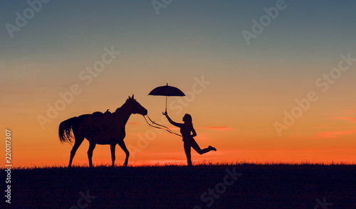 Idyllic friendship scene with horse silhouette  horsemanship concept. Horse and girl with open umbrella on romantic sunset. 