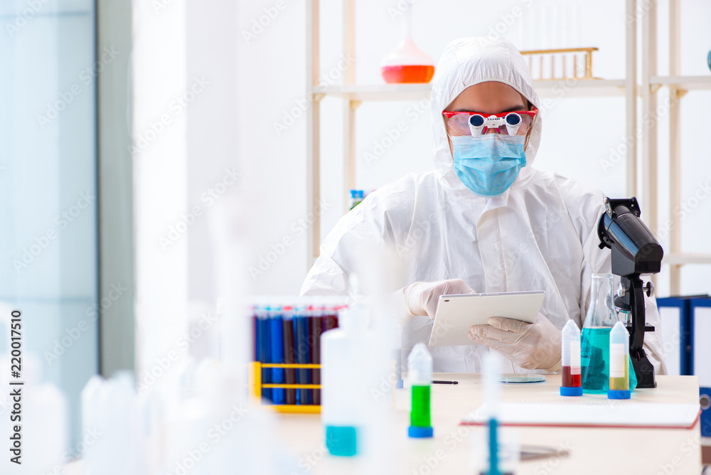 Young chemist student working in lab on chemicals Young chemist student working in lab on chemicals