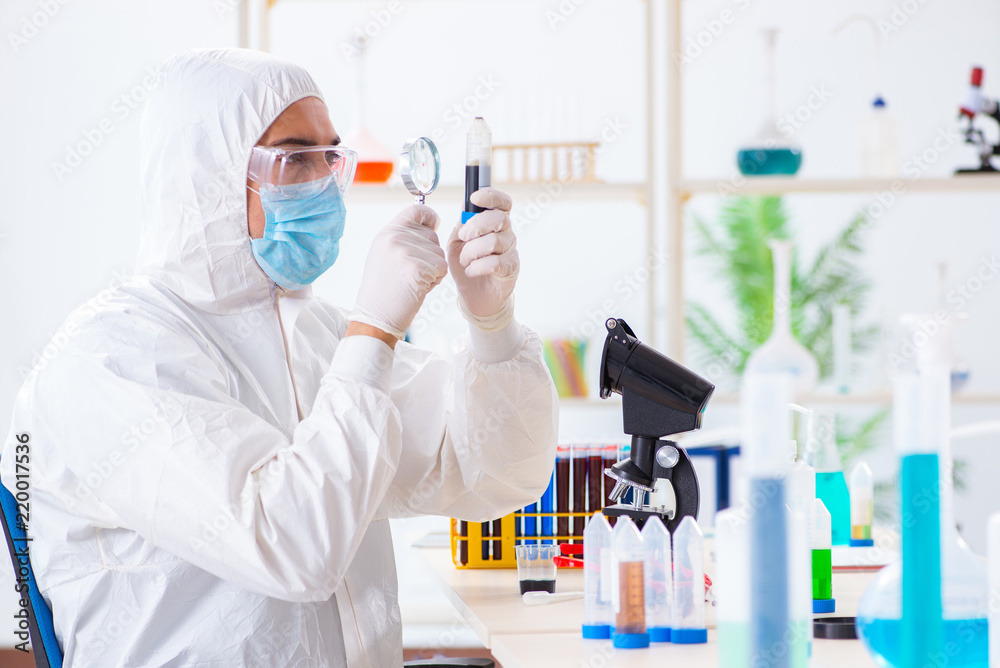 Young chemist student working in lab on chemicals Young chemist student working in lab on chemicals