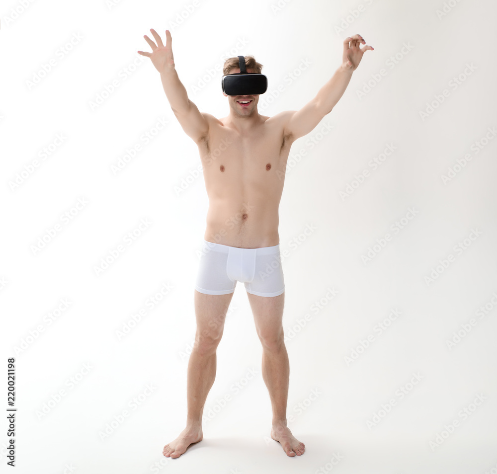 Handsome man using VR glasses. Virtual reality experience. 3d technology, virtual reality, entertainment, cyberspace. Man in underwear with virtual reality headset, 3d glasses. Virtual reality goggles