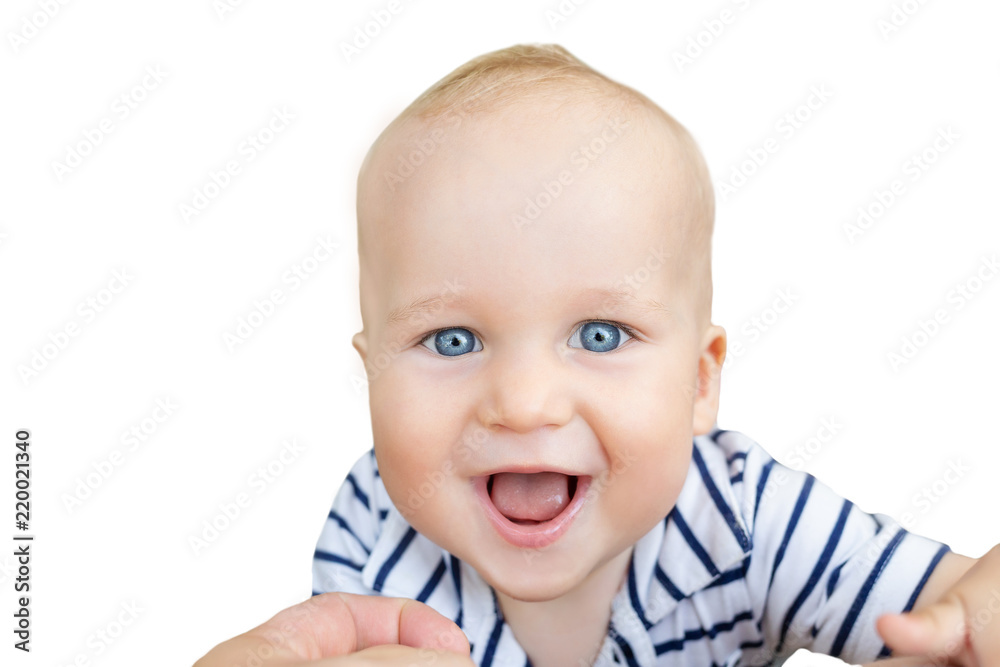 Close-up portrait of cute caucasian baby boy smiling and having fun with parents outdoors. Happy infant face with big blue eyes,sweet smile and green grass lawn on background. Isolated on white Close-up portrait of cute caucasian baby boy smiling and having fun with parents outdoors. Happy infant face with big blue eyes,sweet smile and green grass lawn on background. Isolated on white