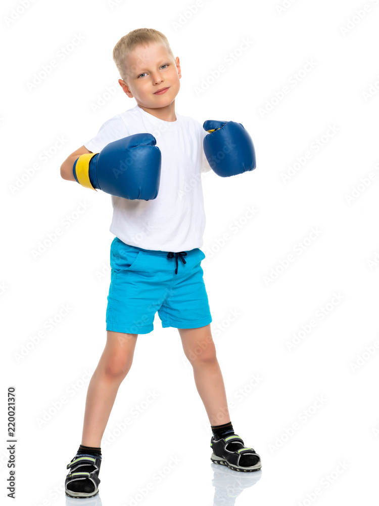 A little boy in a clean white T-shirt and boxing gloves.