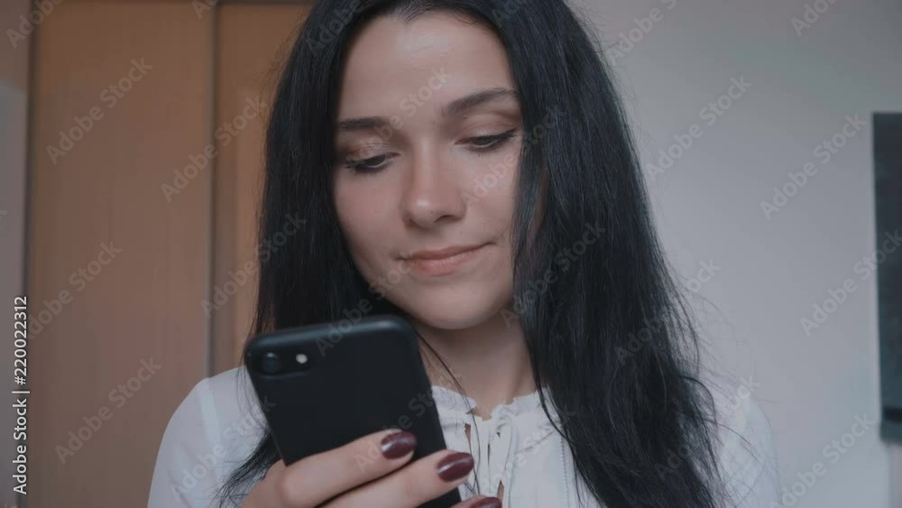 portrait of young woman brunette using smartphone at home portrait of young woman brunette using smartphone at home