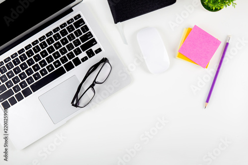 Top view of laptop computer with open display screen monitor, diary and mouse and notepad, glasses and pencil isolated on white background, notebook or netbook, communication technology concept.