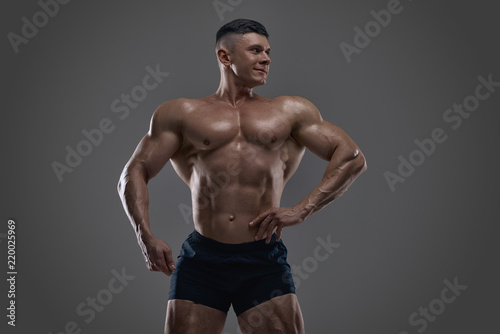 Muscular bodybuilder guy doing exercises