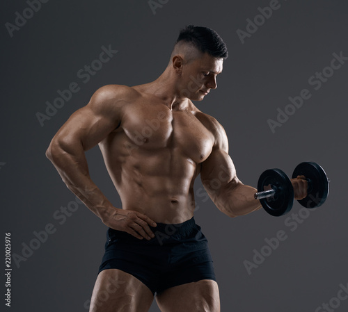 Muscular bodybuilder guy doing exercises © bondarchik