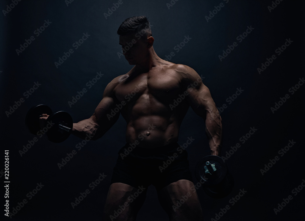 Muscular bodybuilder guy doing exercises