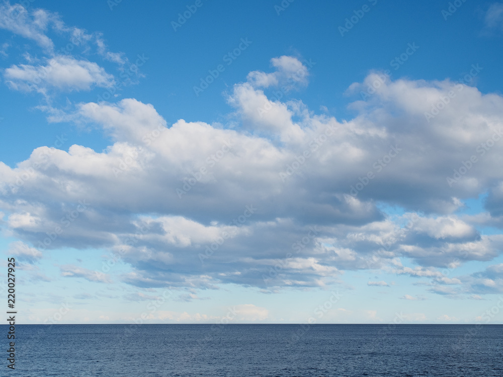 Clouds in blue sky over sea