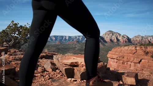 Woman Walking Over Rocks on Desert Mountaintop