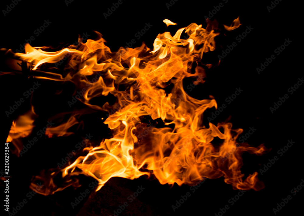 Flame of fire with sparks on a black background Flame of fire with sparks on a black background
