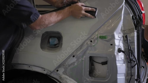 Auto body technician repairing a vehicle.
