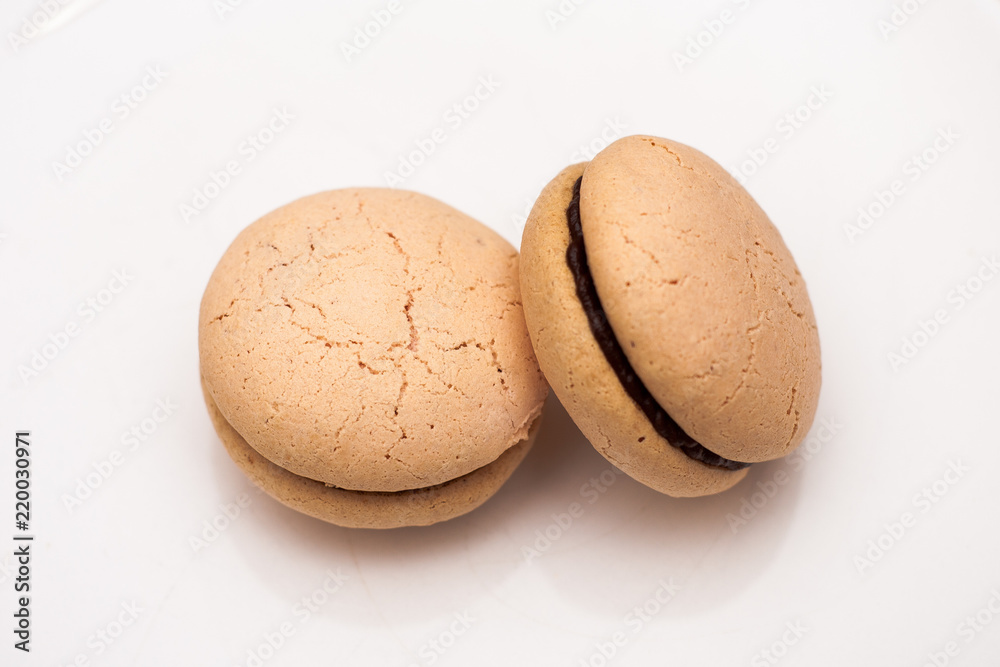 Macarons with chocolate filling on a white plate Macarons with chocolate filling on a white plate