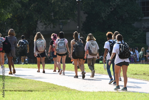 A group of female students walk across the campus of UNC Chapel Hill