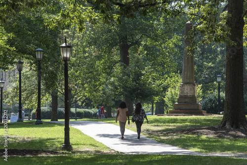 Students at UNC Chapel Hill walk around campus on a humid morning photo