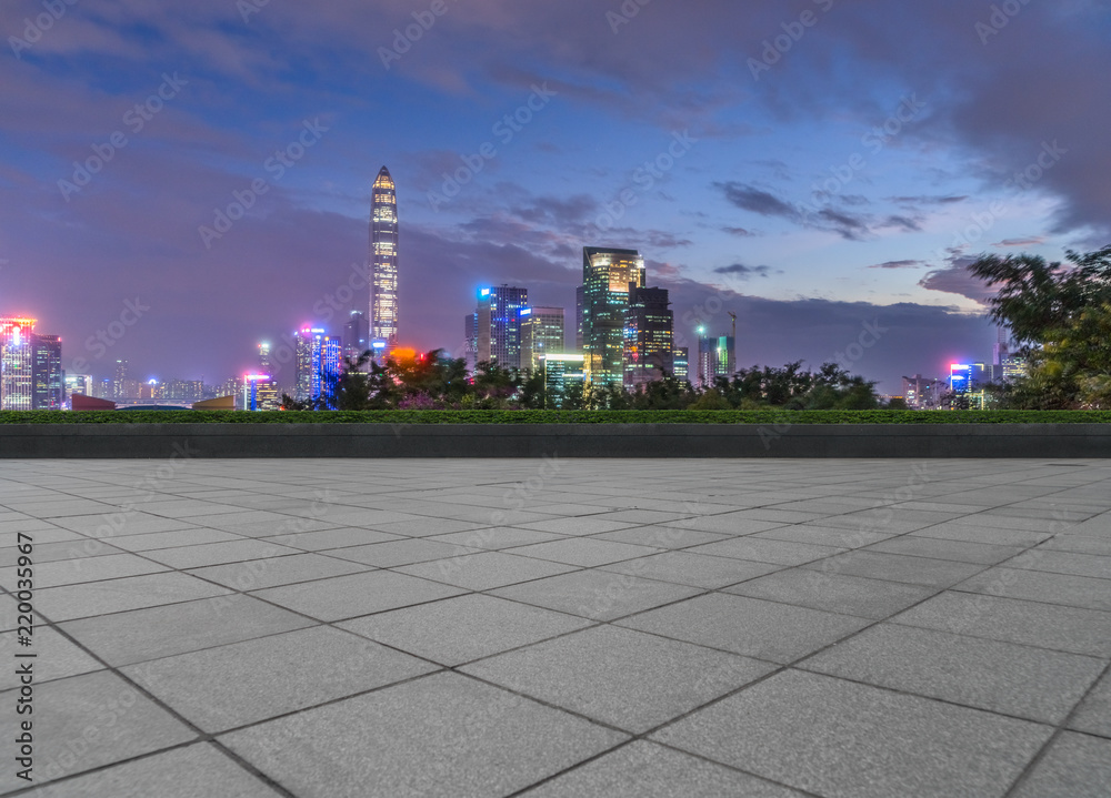 night view of empty brick floor front of modern building night view of empty brick floor front of modern building