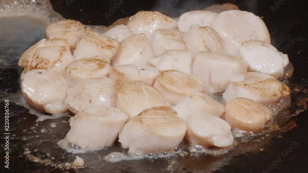 Macro of scallops frying with the butter Macro of scallops frying with the butter