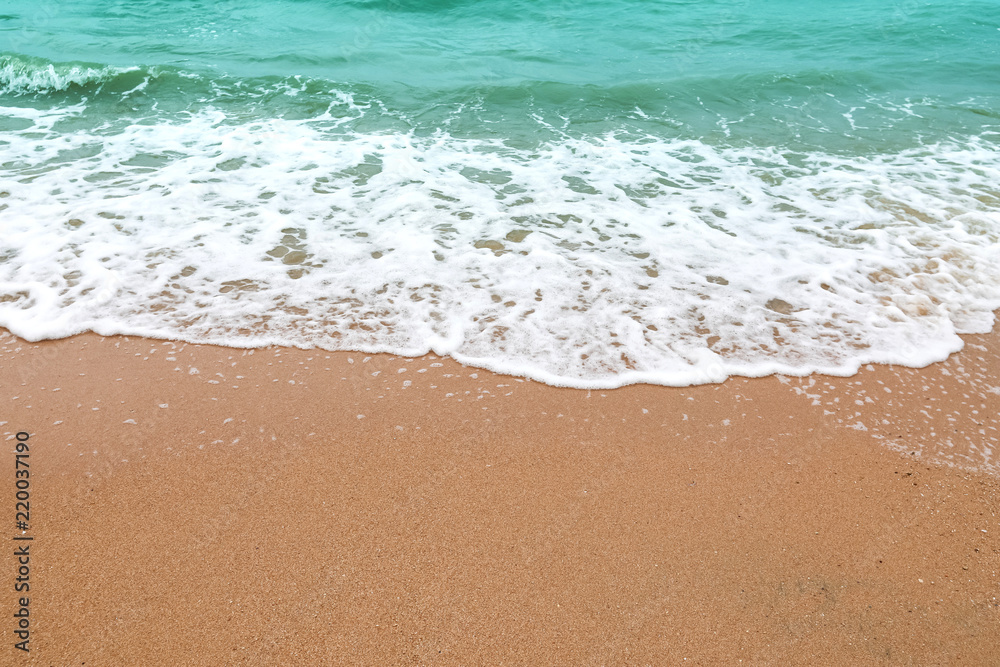 Soft wave of blue ocean on sandy beach. background. selective focus. beach and tropical sea white foam on beach. soft focus on bottom of picture. Soft wave of blue ocean on sandy beach. background. selective focus. beach and tropical sea white foam on beach. soft focus on bottom of picture.