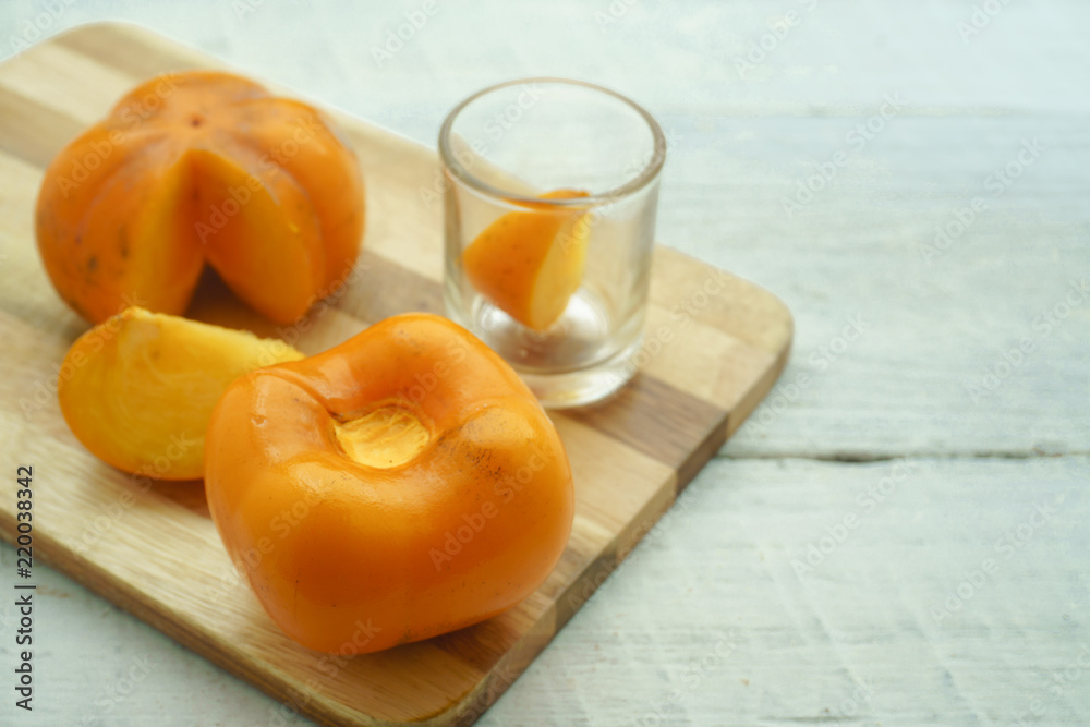 Persimmon on a white background, persimmon orange in front view Persimmon on a white background, persimmon orange in front view