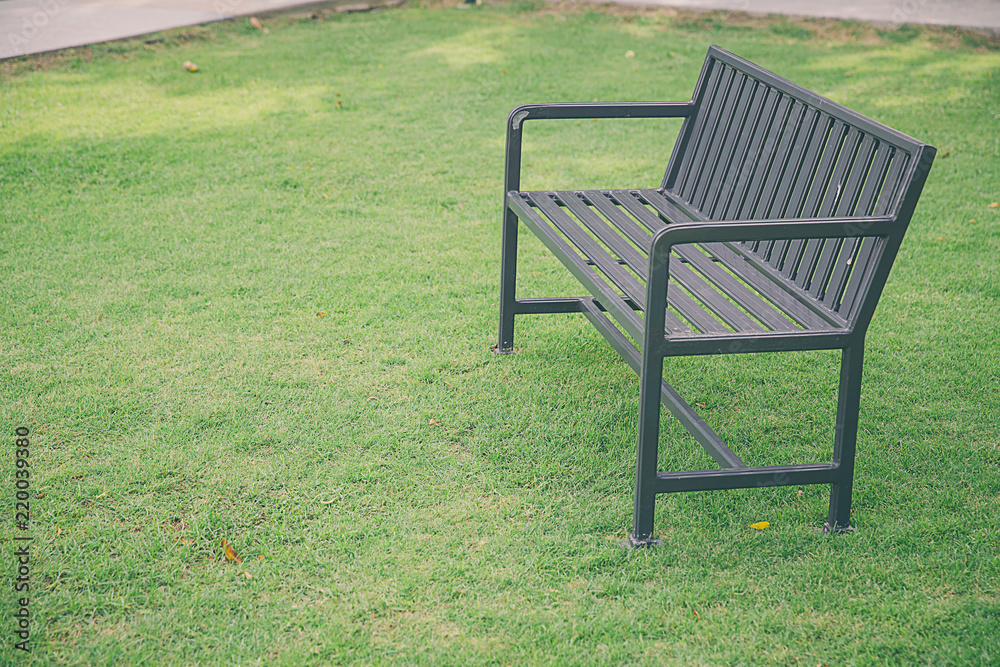 Stylish bench in summer park. public chair in the garden at morning and tree in nature background,Public chair in the park . Blank old bench in the public park. Stylish bench in summer park. public chair in the garden at morning and tree in nature background,Public chair in the park . Blank old bench in the public park.