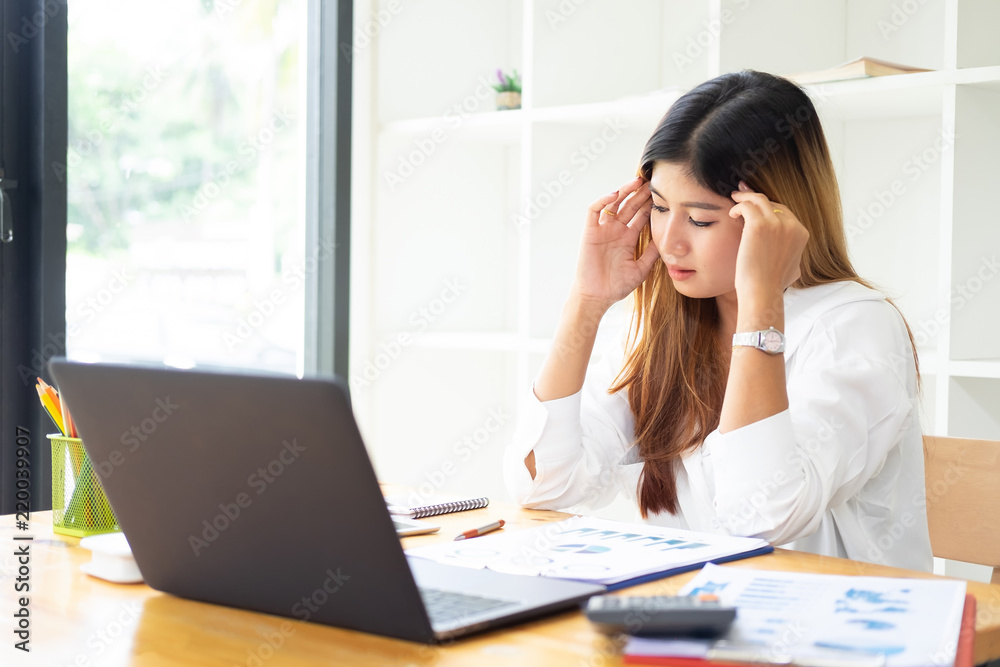 Businesswoman touching massaging stiff head to relieve pain in muscles working in incorrect posture. Businesswoman touching massaging stiff head to relieve pain in muscles working in incorrect posture.