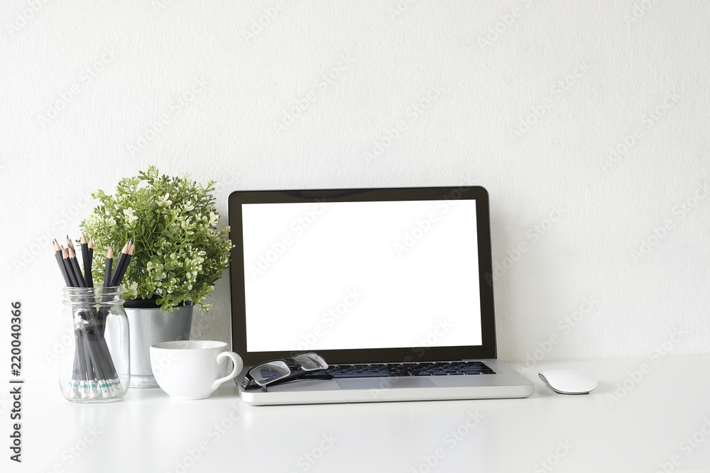 Workspace laptop computer, coffee cup and plant decorate on white office desk. Workspace laptop computer, coffee cup and plant decorate on white office desk.