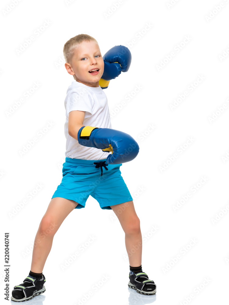 A little boy in a clean white T-shirt and boxing gloves. A little boy in a clean white T-shirt and boxing gloves.