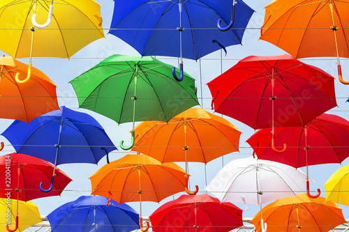  Colorful umbrellas background. Bright umbrellas in the sky. Street design.