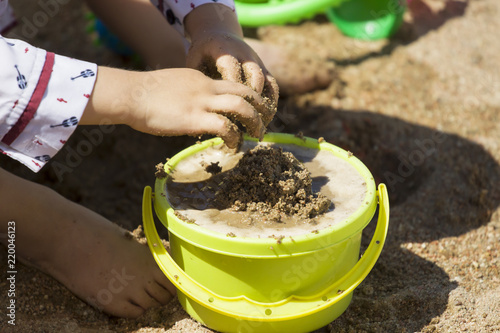 Playing with sand and water in the sand children's hands