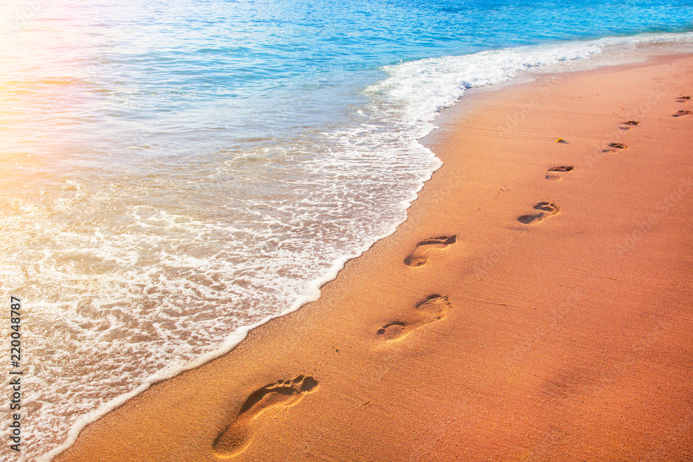 beach, wave and footprints at sunset time beach, wave and footprints at sunset time
