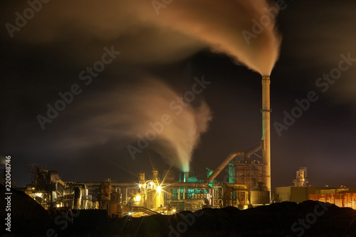 Atmospheric Air Pollution From Industrial Smoke Now. Pipes Steel Plant. Thick Smoke and Steam of MDF Production. Works in Cloudy Day at night. Environmental pollution. Slow shutter speeds
