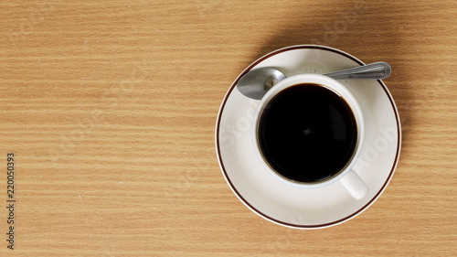 Black coffee cup on wooden table with above