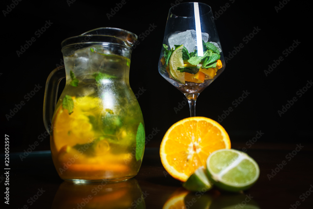 Tea on a black background. Fruit tea. Cold tea. Teapot with tea. Tea on a black background. Fruit tea. Cold tea. Teapot with tea.