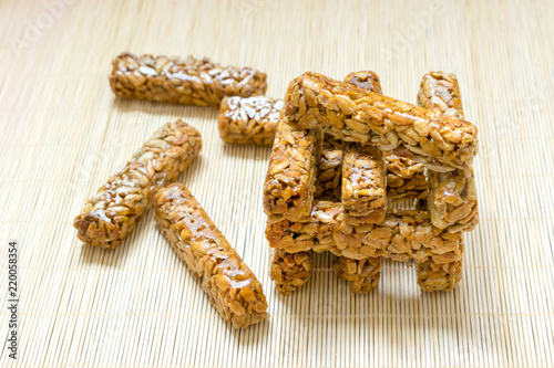 Tower, stack, janga from the scattered snacks. Sunflower seed brittle gosinach kozinaki. Tasty sweets snack. Nutritious and delicious healthy dessert. Pressed sunflower seeds candied in sweet syrup.