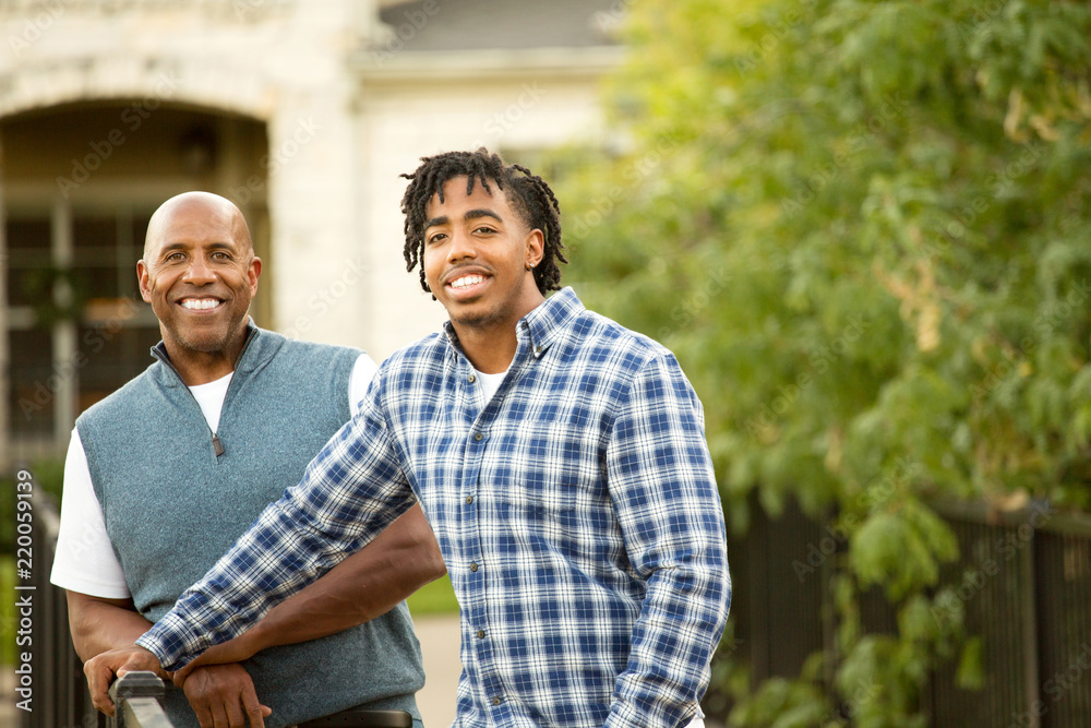 African American father and his adult son. African American father and his adult son.