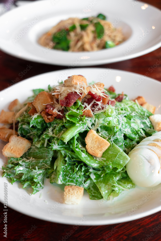 Caesar salad plate with cheese and croutons Caesar salad plate with cheese and croutons