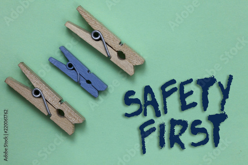 Conceptual hand writing showing Safety First. Business photo showcasing Avoid any unnecessary risk Live Safely Be Careful Pay attention Three brown blue vintage clear background Holding things photo