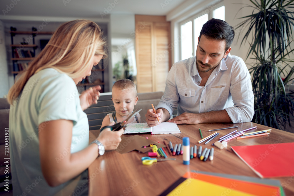 Mom ,dad and son draw in the living room Mom ,dad and son draw in the living room