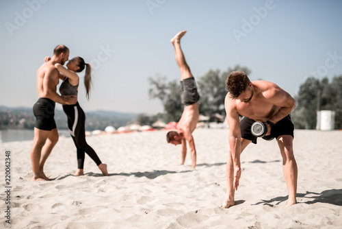 Love and sport. a group of people exercise on the beach. 