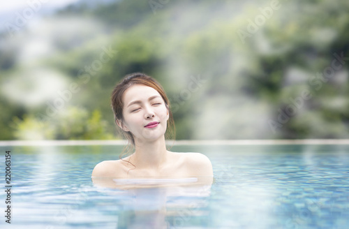Young  woman relaxing in hot springs © Tom Wang