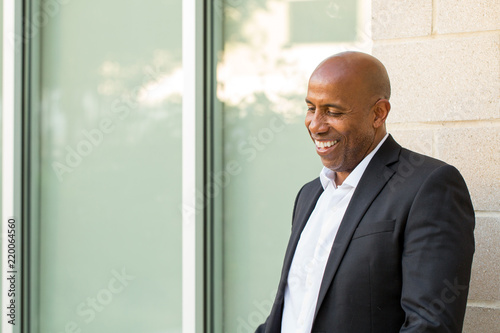 Mature African American casually dressed businessman smiling.