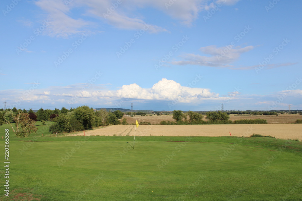 Golf green overlooking farmers field