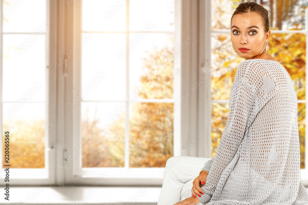 Slim young woman and window with autumn landscape. Free space for your decoration. Slim young woman and window with autumn landscape. Free space for your decoration.
