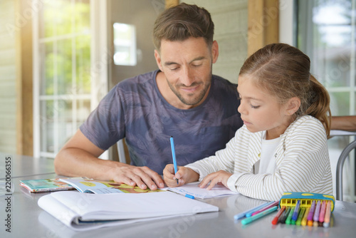 Daddy with little girl doing homework photo