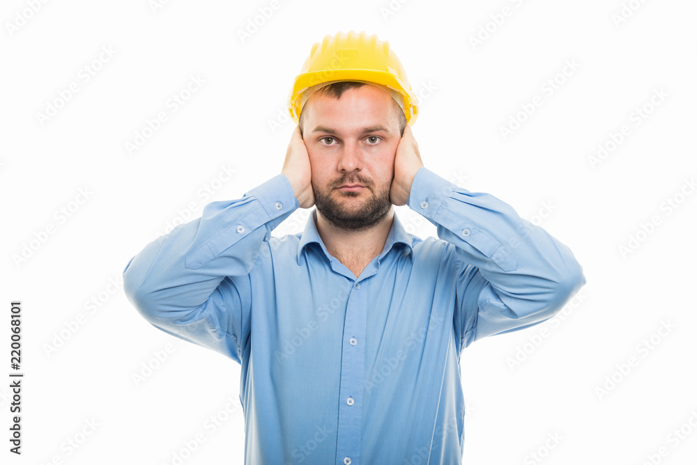 Young architect with yellow helmet covering ears