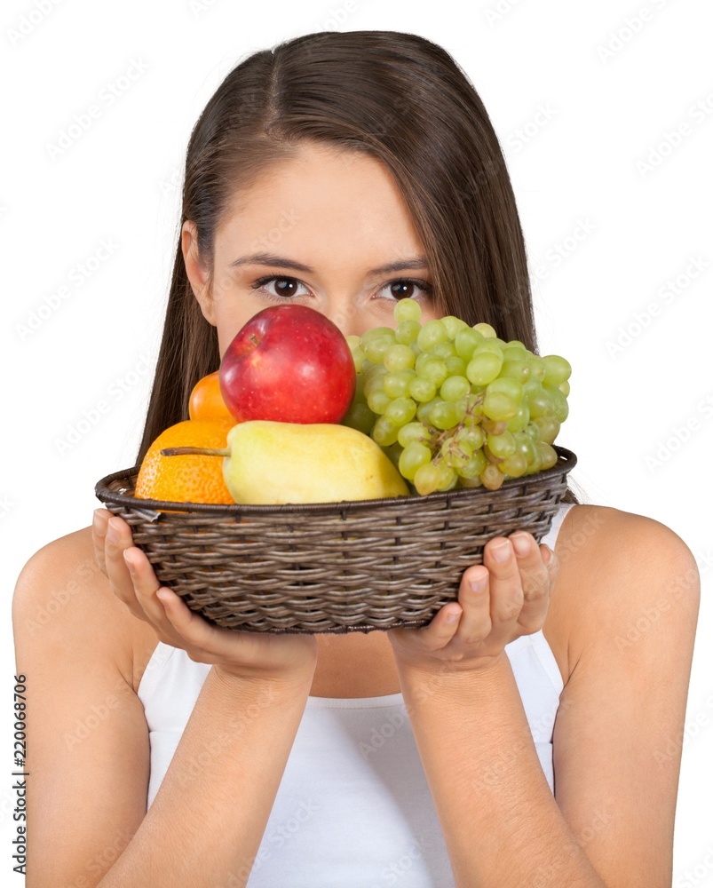 Young beautiful woman holding basket with fruits isolated on Young beautiful woman holding basket with fruits isolated on
