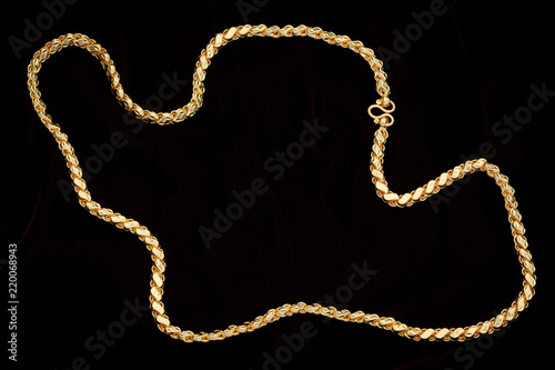 Golden chain on a dark pattern