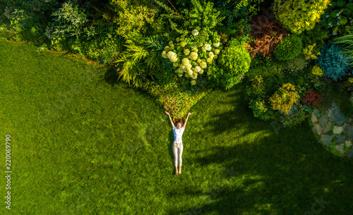top view portrait of a pretty young woman relaxing on a grass