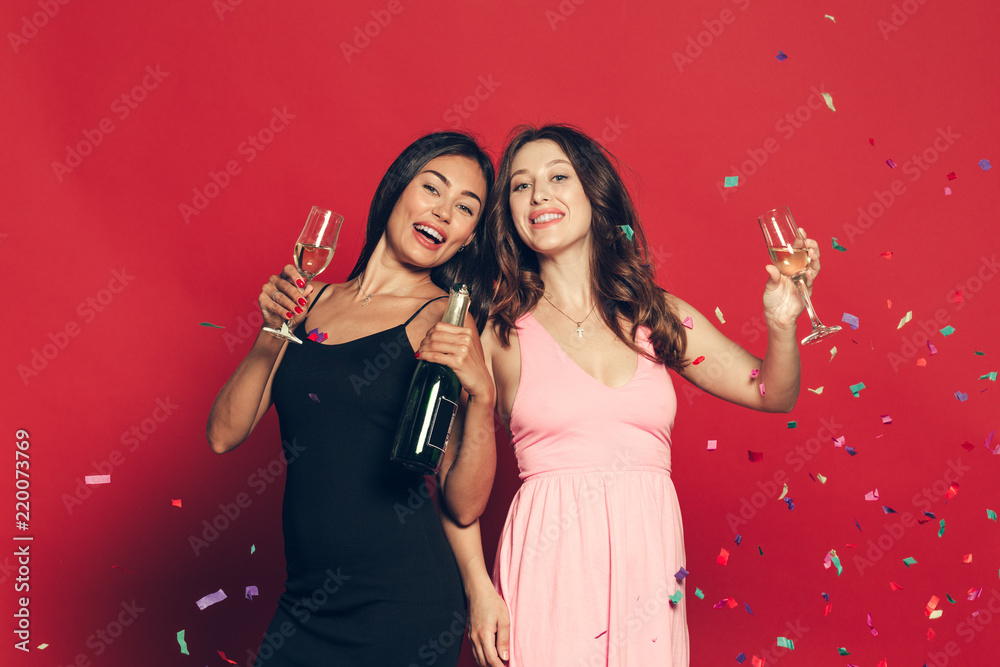 Plakat young womans with a champagne glasses at celebration