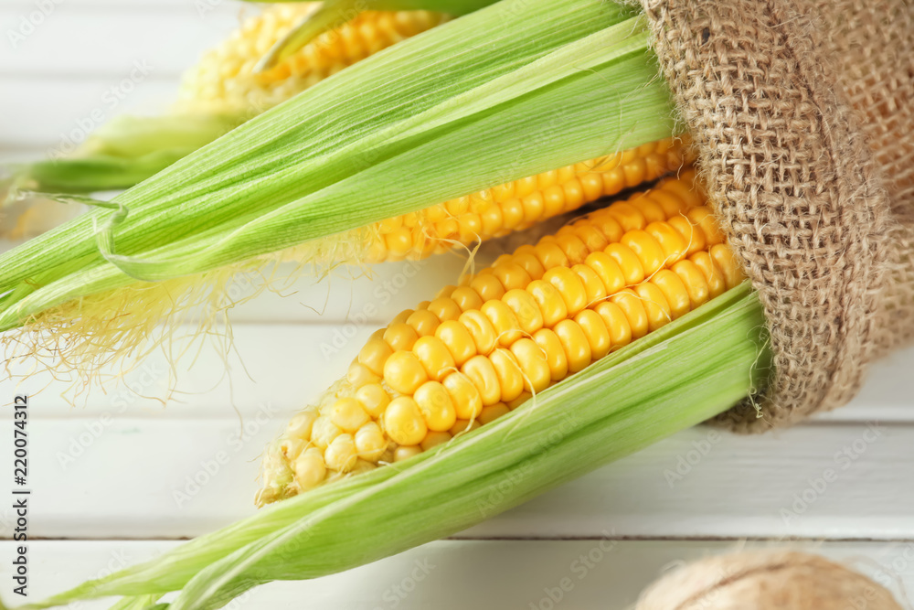 Ripe corn cobs on wooden background, closeup Ripe corn cobs on wooden background, closeup